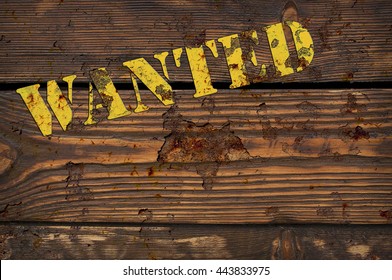 WANTED - yellow rusty iron sign on the vintage brown wooden wall - western style