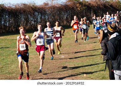 Wappinger Falls, New York, USA - 23 November 2019: High School Boys Racing On A Downhill Running A 5K Race In A Park With Fans Cheering.
