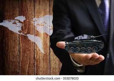 War Business Concept, Businessman Offer War Tank In Hand