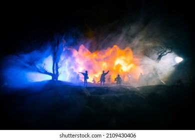 War Concept. Military Silhouettes Fighting Scene On War Fog Sky Background, World War Soldiers Silhouette Below Cloudy Skyline At Night. Armored Vehicle Fight Scene. Selective Focus