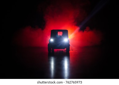 War Concept. Military silhouettes fighting scene on war fog sky background, World War Soldiers Silhouettes Below Cloudy Skyline At night. Attack scene. Armored vehicles. Trucks and army jeep