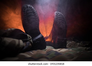 War concept. Old military shoe in a dark toned foggy background. Boots on soldier who KIA (Killed in action). Selective focus