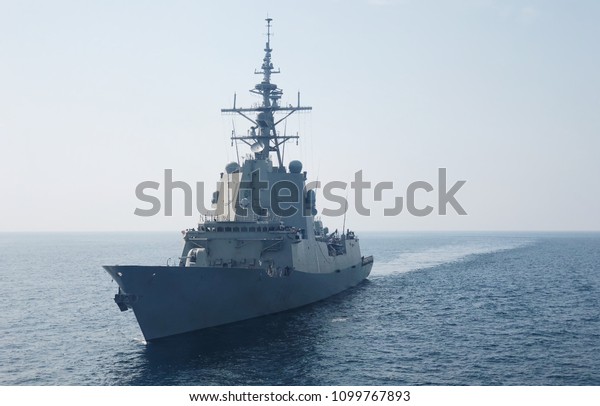 A war frigate\
ship sailing at sea in\
summer.