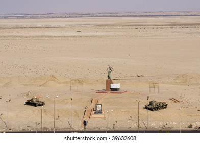 A War Memorial Statue In Suez Canal And Tanks