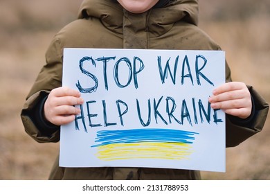 War of Russia against Ukraine. Ukrainian Crying boy asks to stop the war in Ukraine. Child with message Stop War.