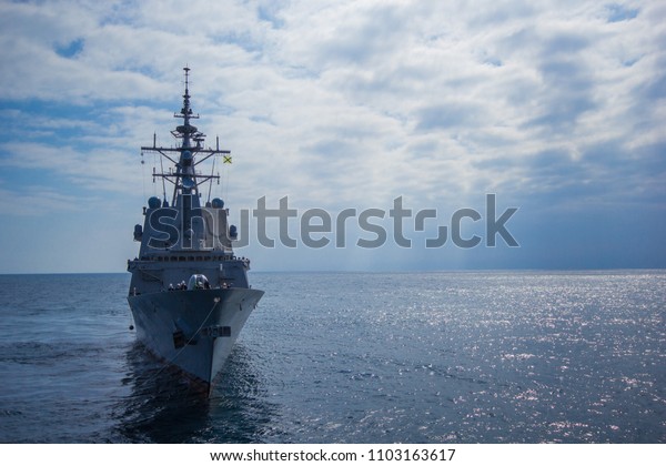 A war ship frigate at sea\
in a nato operation against piracy. A nato military grey vessel  at\
sea.