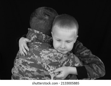 War In Ukraine. Military And Children. Ukrainian Soldier Hugs A Child. Army Protects Country Population From Invaders. Terrorist Activities In The Country. Camouflage Uniform Of Ukrainian Military