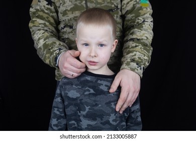 War In Ukraine. Military And Children. Ukrainian Soldier Hugs A Child. Army Protects Country Population From Invaders. Terrorist Activities In The Country. Camouflage Uniform Of Ukrainian Military