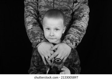 War In Ukraine. Military And Children. Ukrainian Soldier Hugs A Child. Army Protects Country Population From Invaders. Terrorist Activities In The Country. Camouflage Uniform Of Ukrainian Military