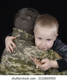 War In Ukraine. Military And Children. Ukrainian Soldier Hugs A Child. Army Protects Country Population From Invaders. Terrorist Activities In The Country. Camouflage Uniform Of Ukrainian Military