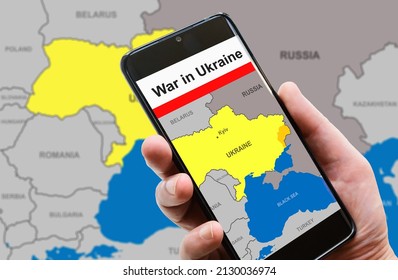 War in Ukraine on smartphone screen. Media news, military conflict in mobile phone. Ukraine and Russia borders with Donbass on Europe map. Concept of social network, internet, fake, online and crisis - Shutterstock ID 2130036974