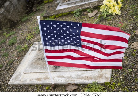 War Veterans Grave Marker with United States Flag Blowing