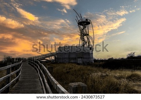 
The Warandetoren during a beautiful sunset located in the Belgian coastal city of Middelkerke.  Golden hour at the flanders belgium coast with view on tower in Middelkerke.  Toerism flanders coast.