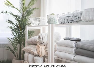 Wardrobe in the bedroom with neatly folded linen vertical storage and stacks. White interior in Scandinavian style and linen in neutral shades. - Shutterstock ID 2185695095