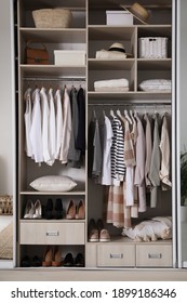 Wardrobe Closet With Different Stylish Clothes, Shoes And Home Stuff In Room