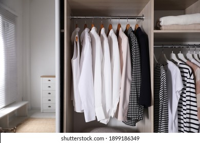 Wardrobe Closet With Different Stylish Clothes In Room, Closeup