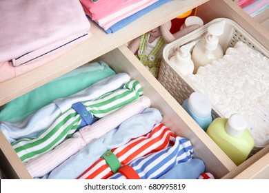 Wardrobe with clothes and necessities in baby room