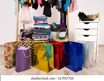 Wardrobe With Clothes And Shopping Bags, On Line Shopping. Close Up On Many Full Bags In A Woman Closet.