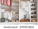 Wardrobe with different clothes and accessories in dressing room