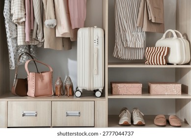 Wardrobe with different neatly organized clothes and home stuff