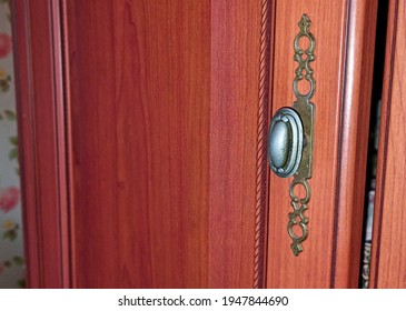 The Wardrobe Door With Its Elegant Handle Is Ajar