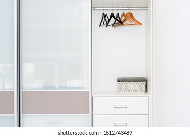 Wardrobe with empty shelves and hangers. White minimalist scandinavian interior. - Powered by Shutterstock