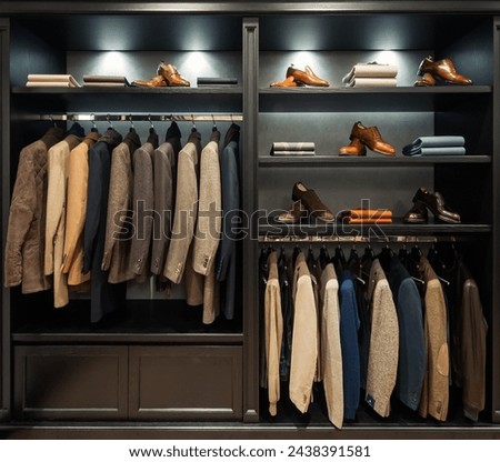 Wardrobe with man costumes. Two dimensional image of closet in apparel boutique. Black built-in furniture.