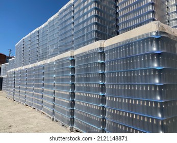 Warehouse Of Bottles At The Factory. Large Packs Of Plastic Empty Bottles. Glass Bottles In Polyethylene Packaging. Preparation Of Bottles In Production.