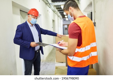 The Warehouse Clerk And The Boss Check The Delivery Of Goods With A Checklist In The Shipping Company's Warehouse