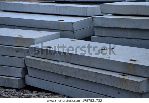 warehouse of
concreting panels in the concrete plant. production of ceiling
lintels for the construction of houses, flat bridges and roads.
gray heavy objects moved by a
crane