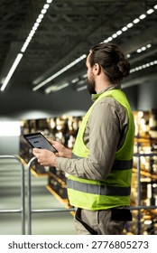Warehouse employee, tracking software, tablet in warehouse, standing on platform and ensuring express delivery for order fulfillment. Airway bill data for e-commerce operations.