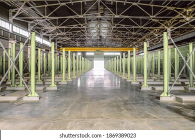 Warehouse of engineering plant shop with yellow overhead crane. Empty storage areas of new metalwork production hall. - Shutterstock ID 1869389023