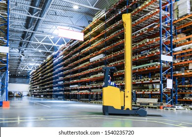 warehouse forklift in motion at the warehouse on the background of blurry storage racks. reach truck in a warehouse - Powered by Shutterstock