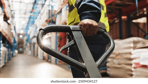 Warehouse, hand and worker pull pallet truck for supply chain, restock or moving freight. Factory, person and trolley for cargo storage, distribution logistics and back in shipping industry closeup - Powered by Shutterstock