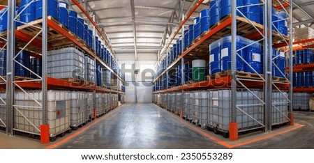 Warehouse hangar. Multi-tier shelving. Warehouse with barrels. Storage of fuels and lubricants. Plastic and metal tanks on pallets. Place for storing fuel and lubricants. Warehouse logistics