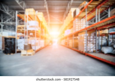 Warehouse industrial and logistics companies. Long shelves with a variety of boxes and containers. Bright sunlight. Deep blur effect.