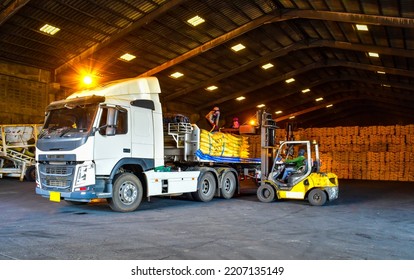 Warehouse Intake, Forklift Unloading Bags Of Sugar Cargo From Truck To Stack Inside A Warehouse. Sugar, Grain, Food, Rice, Maize, Cargo In Bags Handling Concept.