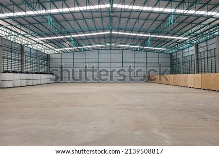 Warehouse interior background . A brand new industrial shed. Store factory. Industry warehouse space and hardware box for delivery with copy space.  