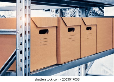 Warehouse Interior With Cardboard Boxes On Shelves Close Up