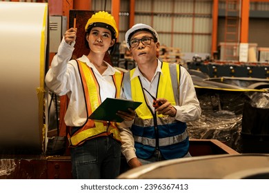 Warehouse inventory management in metalwork factory with engineer or inspector conduct storage check and quality control assessment on cylinder rolled metal for civil engineering project. Exemplifying - Shutterstock ID 2396367413