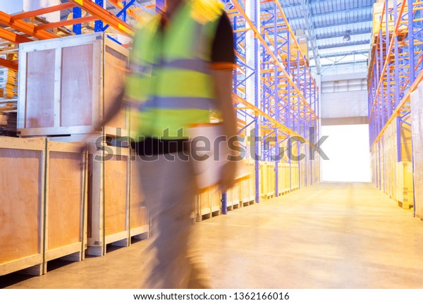 warehouse inventory with\
management. motion blur of warehouse worker are working in\
warehouse, 