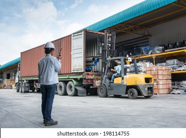 warehouse laborer team at unloading works with forklift loader