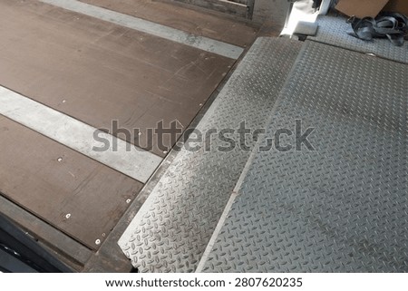 Warehouse loading dock leveler with anti slip steel platform for truck loading and unloading, industrial logistics dock equipment, freight handling area and distribution center infrastructure