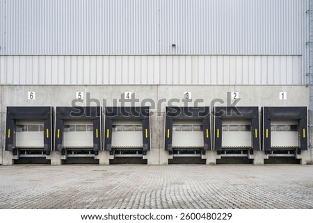 Warehouse loading docks or loading bays for trucks in large logistic area, transportation concept
