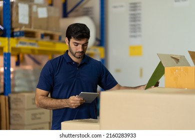 Warehouse male worker working with digital ipad for work in the warehouse near shelf pallet of products or parcel goods. - Powered by Shutterstock