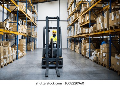 Warehouse Man Worker With Forklift.