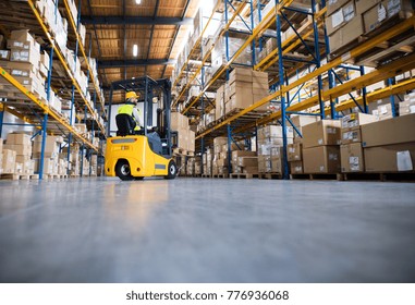 Warehouse man worker with forklift. - Shutterstock ID 776936068