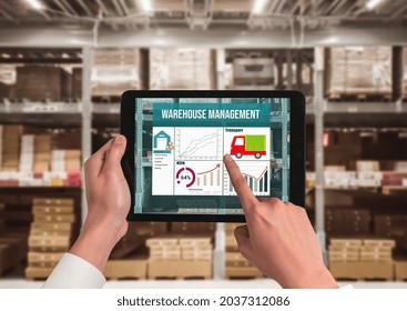 Warehouse management innovative software in computer for real time monitoring of goods package delivery . Computer screen showing smart inventory dashboard for storage and supply chain distribution .