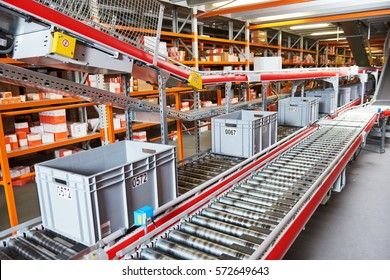 warehouse management system. Conveyer with automaticaly moving boxes - Shutterstock ID 572649643