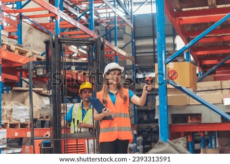 Warehouse management team use bar code scaner scan goods shelf writing checklist on clipboard. Asian men women worker check stock inventory. Teamwork logistics staff counting products store inventory